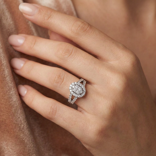 Close-up of a hand wearing a diamond ring with a soft focus background