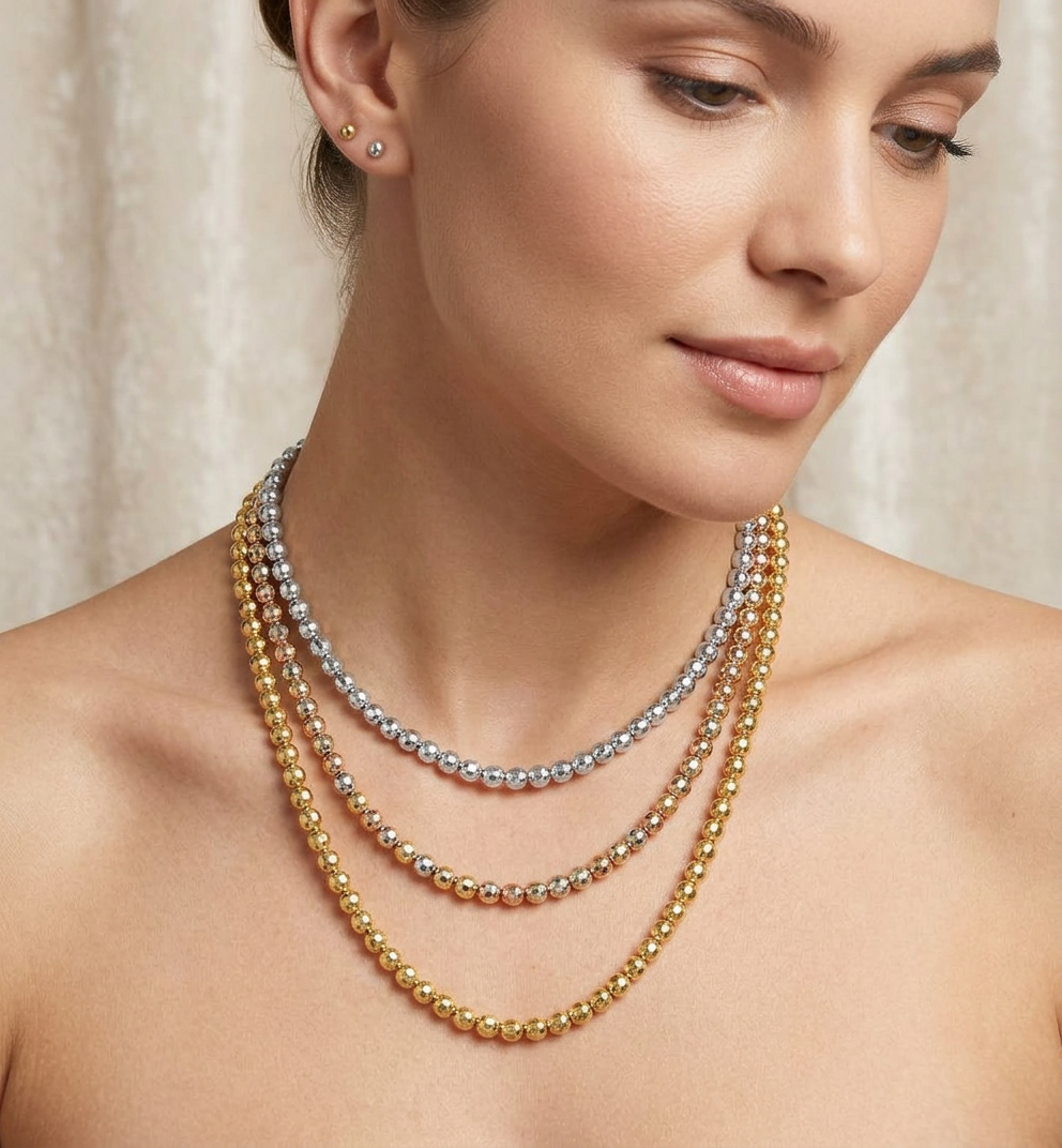 woman wearing three beaded necklaces