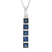 Blue sapphire necklace with a silver chain on a white background