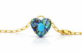 Gold bracelet with a heart-shaped abalone shell and turquoise stone on a white background