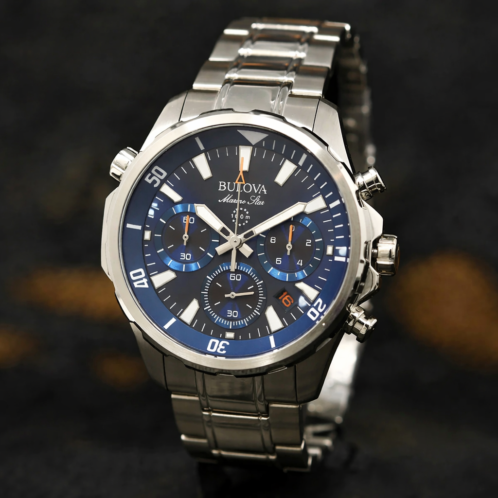Bulova watch with blue face and silver metal strap on a dark background