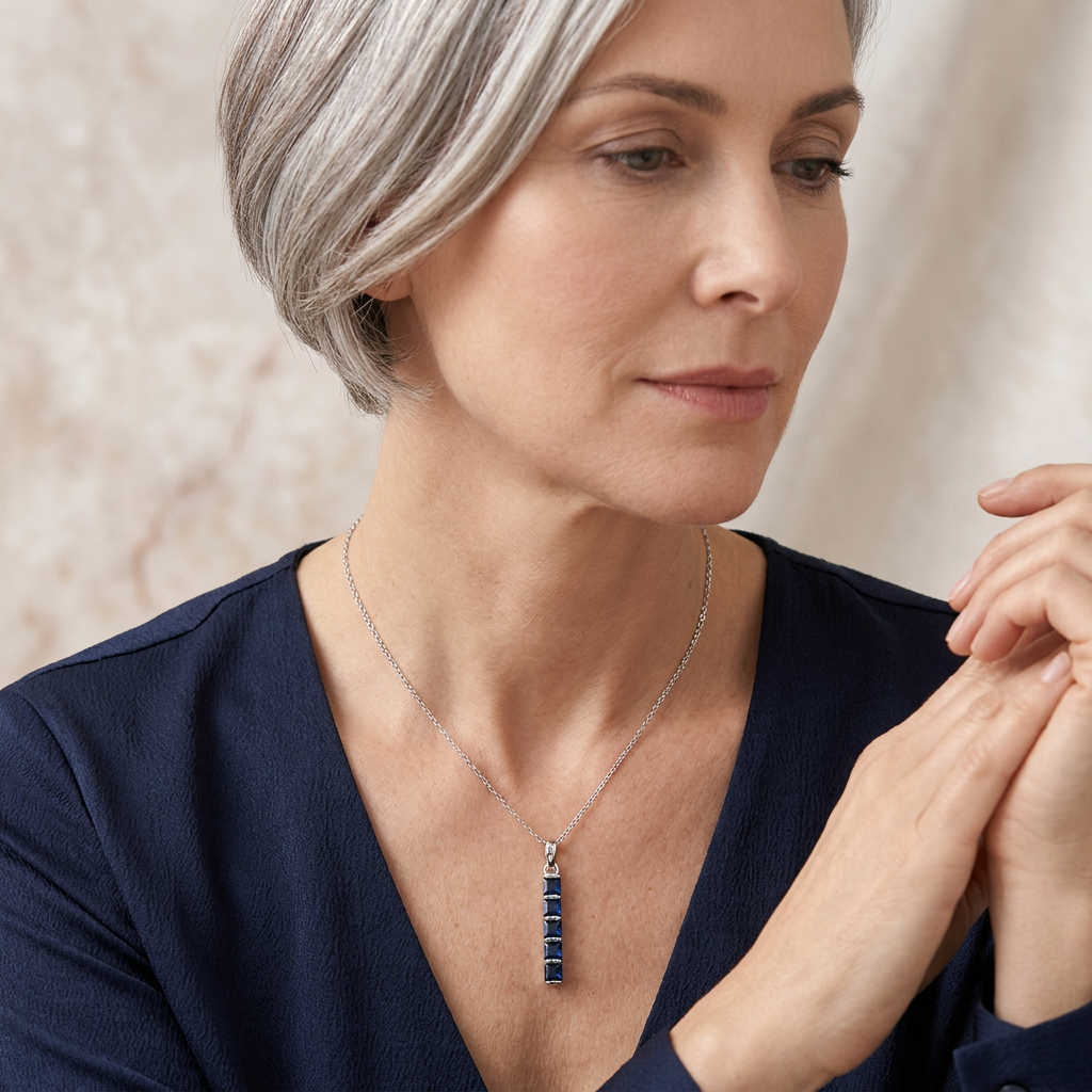 woman wearing a blue sapphire pendant 