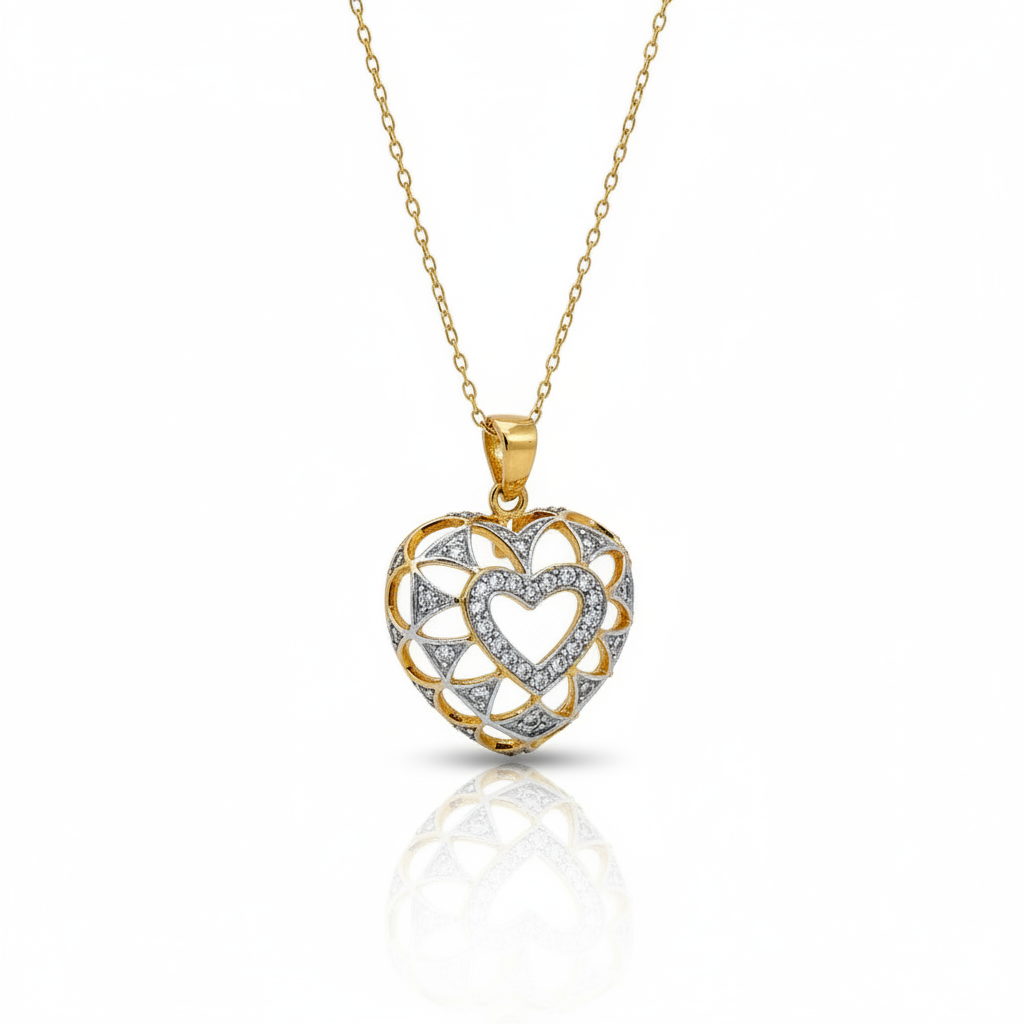 Heart-shaped gold and silver pendant on a white background