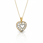 Heart-shaped gold and silver pendant on a white background