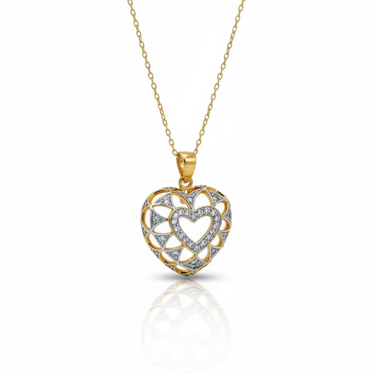 Heart-shaped gold and silver pendant on a white background