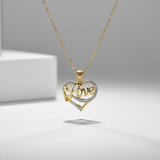 Gold and silver heart-shaped pendant with 'love' engraving on a gray background