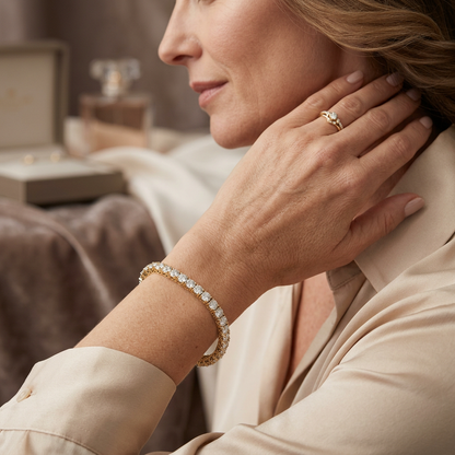 Woman wearing gold and diamond jewelry with a blurred background.