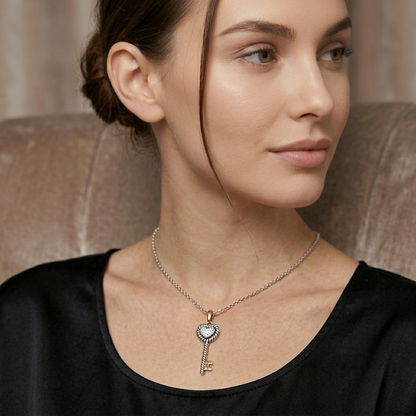 Woman wearing a silver necklace with a key-shaped pendant