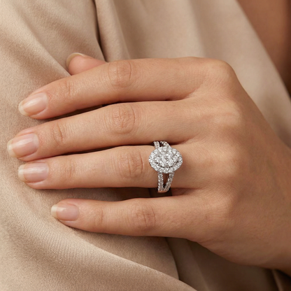Close-up of a hand wearing a diamond ring on a beige fabric background