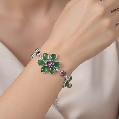 Bracelet with green floral design on a wrist against a neutral background
