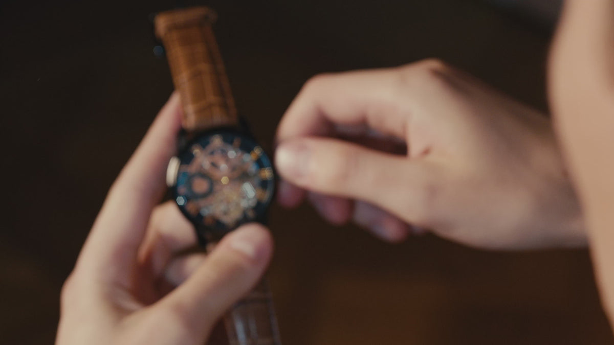 Load video: Thomas Earnshaw Men's 44mm Longitude Automatic Moonphase Skeletonized Leather Strap Watch