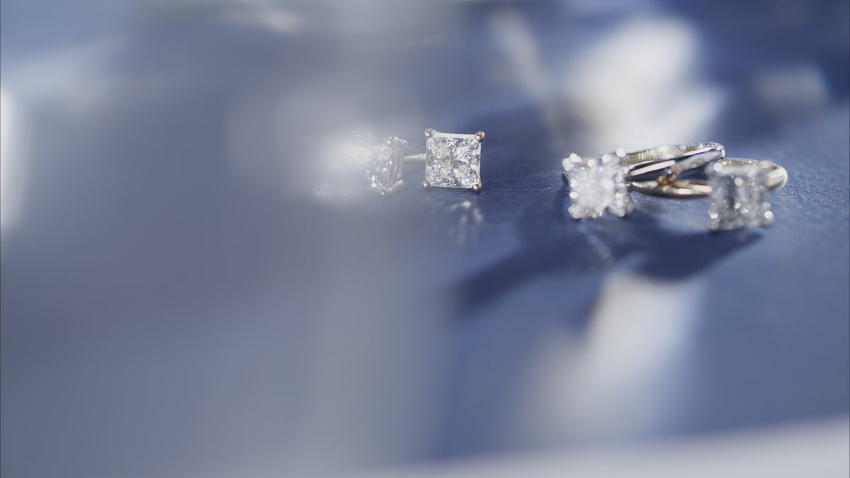 Load video: Close up video of princess cut lab-grown diamond earrings and rings